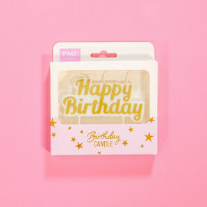 Gold Happy Birthday Candle with three wicks in stylish packaging by Crumbs & Doilies, perfect for birthday cakes.